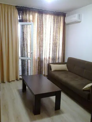 a living room with a couch and a coffee table at Родина- Rey&Mar Apartment in Sveti Vlas