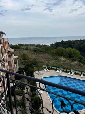 a view of a swimming pool from a balcony at Blue Bay Apartments in Byala