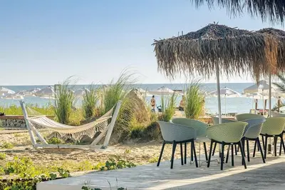 a group of chairs and hammocks on a beach at Apartment Anna-Kalina in Obzor