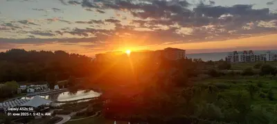 an image of the sun setting over a city at Apartment Anna-Kalina in Obzor