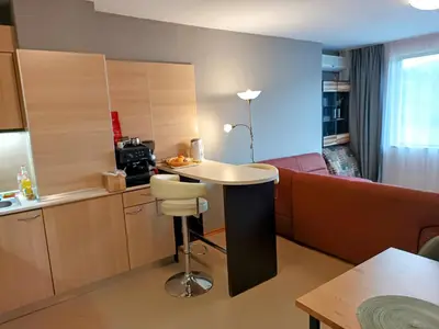 a kitchen with a couch and a table in a room at Hills view apartment in Sunny Beach
