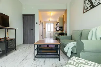 a living room with a couch and a table at Green Dream Apart in Varna City