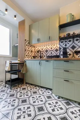 a kitchen with blue cabinets and a tile floor at Green Dream Apart in Varna City