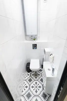 a white bathroom with a toilet and a sink at Green Dream Apart in Varna City
