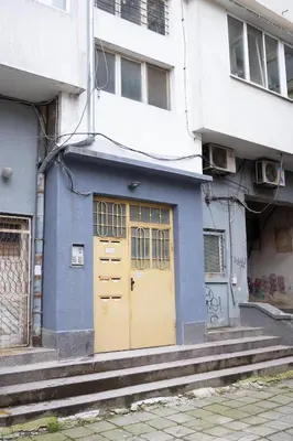 a blue building with yellow doors next to a white building at Green Dream Apart in Varna City