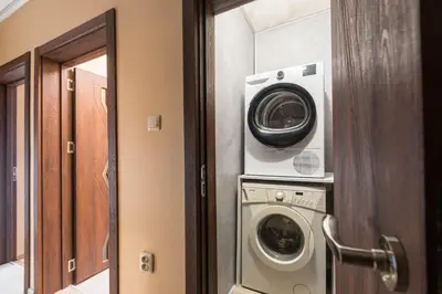 a laundry room with a washing machine and a washer at Downtown Аpartment with Free Parking in Varna City