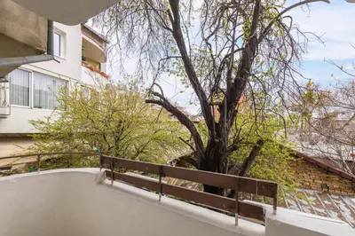 a tree sitting on the side of a balcony at Downtown Аpartment with Free Parking in Varna City
