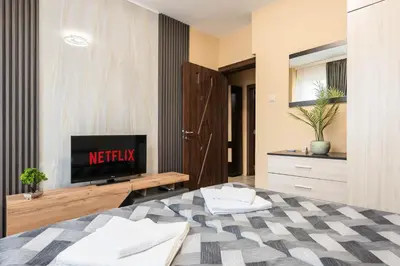 a living room with a bed and a tv at Downtown Аpartment with Free Parking in Varna City