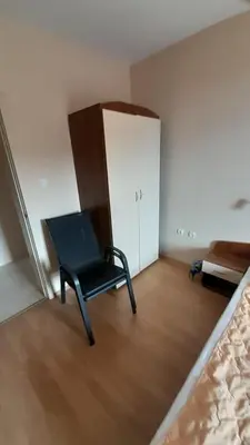 a black chair sitting in a room with a door at Guest House Sveti Vlas in Sveti Vlas