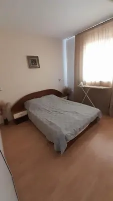 a bedroom with a bed in a room with a window at Guest House Sveti Vlas in Sveti Vlas