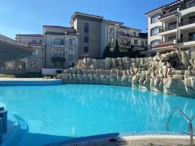 a large swimming pool in front of some buildings at The Vineyard Spa&Resort Apartment with private garden near Aheloy in Kableshkovo