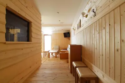 a room with wooden walls and a hallway with benches at The Vineyard Spa&Resort Apartment with private garden near Aheloy in Kableshkovo