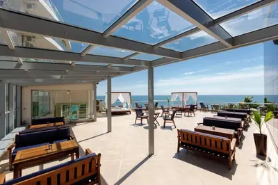 a patio with benches and a view of the ocean at Beach Front Luxurious Two Bedroom Apartment in Byala