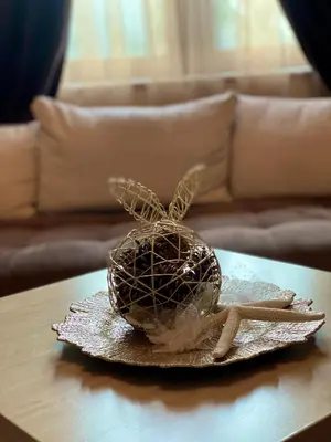 a chocolate ball on a plate on a table at AJ Apartment 8, Santa Marina Holiday Village, Sozopol in Sozopol