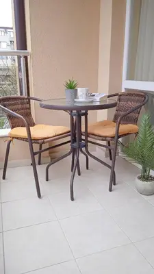 a black table and two chairs and a table and chairs at Апартамент в непосредствена близост до плажа in Burgas City