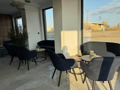 a room with chairs and tables and a window at Aparthotel Sveti Nikola in Pomorie
