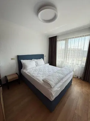 a bedroom with a large bed with a large window at Aparthotel Sveti Nikola in Pomorie