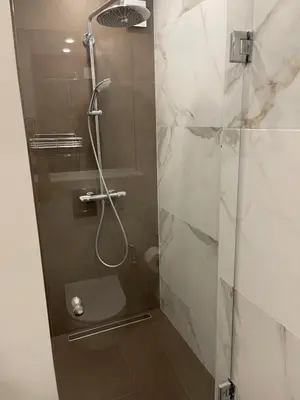 a shower with a glass door in a bathroom at n17 Garden - Parking - WorkDesk - Blackout Rolls- Netflix - Wash&Dry in Burgas City