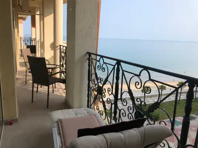a balcony with a couch and a view of the ocean at 2 bedroom apartment komplex Andalusia Elenite with terrasa and sea in Sveti Vlas