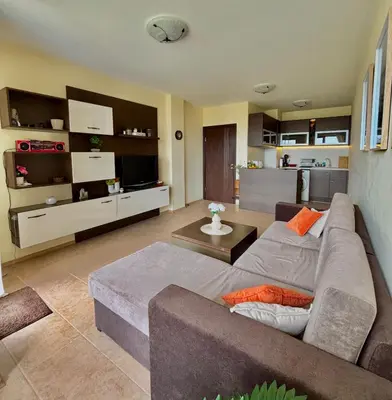 a living room with a couch and a kitchen at Sozopol Dreams Apart&FREE Parking in Sozopol