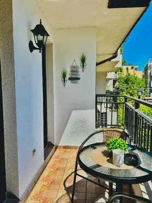 a patio with a table and chairs on a balcony at Sozopol Dreams Apart&FREE Parking in Sozopol