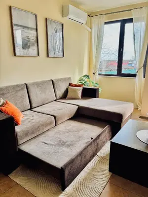 a living room with a couch and a window at Sozopol Dreams Apart&FREE Parking in Sozopol