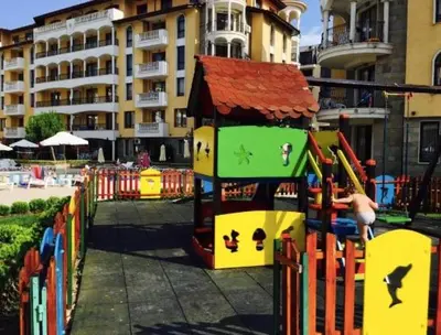 a playground in front of a building with a play structure at Apartment at Royal Sun, Sunny Beach in Sunny Beach