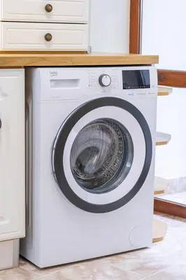 a white washing machine sitting in a kitchen at Lidia Odrin by RV Apartments in Varna City
