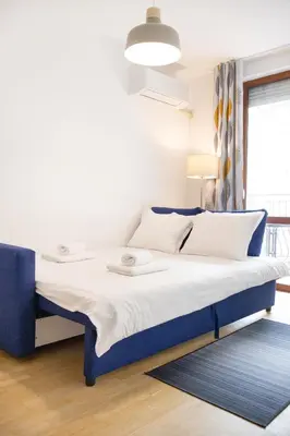 a bed with a blue frame in a room at Lidia Odrin by RV Apartments in Varna City