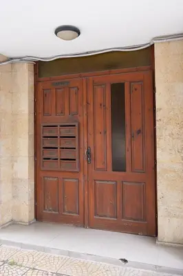 a pair of wooden doors in a building at Lidia Odrin by RV Apartments in Varna City