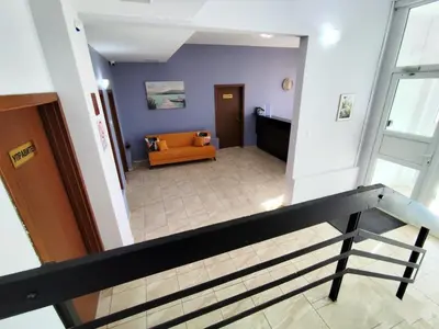 a view of a lobby with a couch and stairs at Хостел Спортна база Ветрен in Burgas City