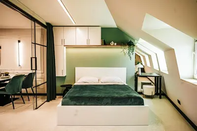 a bedroom with a bed and a table and chairs at The Loft - Parking - Washer&Dryer - Port view - Balcony in Burgas City