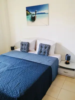 a bedroom with a bed with a blue blanket at Jasmine A17 Cozy Studio Sunny Beach in Sunny Beach