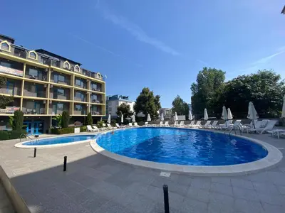 a large swimming pool in front of a hotel at Jasmine A17 Cozy Studio Sunny Beach in Sunny Beach