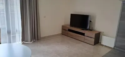 a living room with a flat screen tv on a dresser at Star Dreams P2 in Sveti Vlas