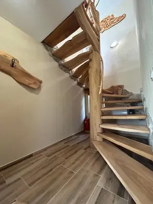 a staircase in a room with wooden floors at Вилно селище Зора in Shkorpilovtsi