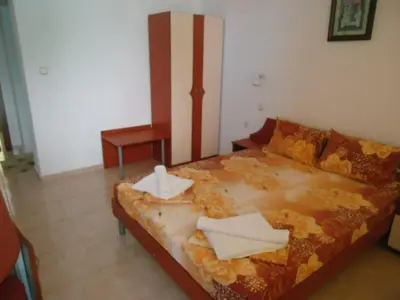 a bedroom with a large bed with leaves on it at Тихия кът in Sozopol
