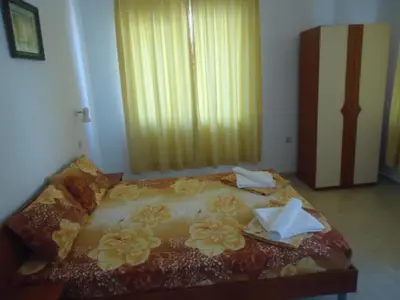 a bedroom with a bed with two napkins on it at Тихия кът in Sozopol