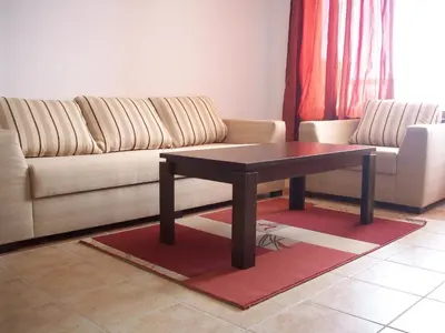 a living room with a couch and a coffee table at Apartments Helios in Pomorie