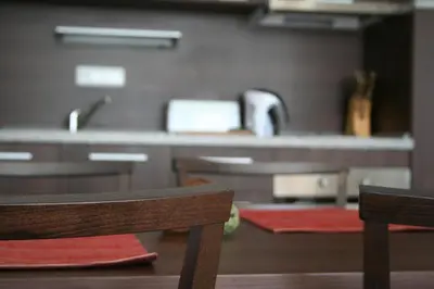 a kitchen with a counter and a table and two chairs at Apartments Helios in Pomorie