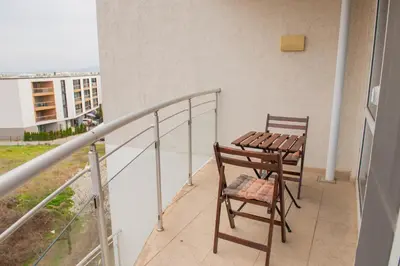 a balcony with two chairs and a table at Atlantis Resort Private 1BD apart by Flat Mаnager in Burgas City
