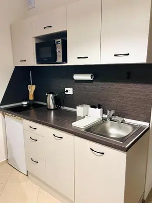 a kitchen with a sink and a microwave at La Dahlia studio - Cascadas family resort in Sunny Beach