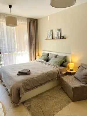 a bedroom with a large bed and a window at La Dahlia studio - Cascadas family resort in Sunny Beach