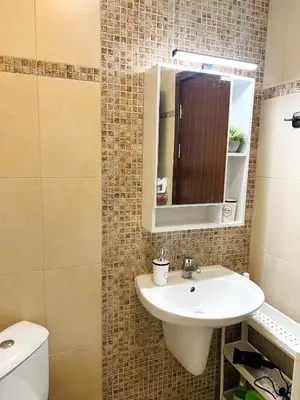 a bathroom with a sink and a mirror and a toilet at La Dahlia studio - Cascadas family resort in Sunny Beach