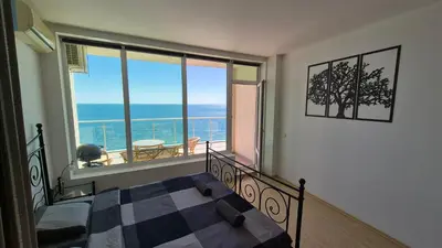 a bedroom with a bed and a view of the ocean at Amazing panorama sea view apartment in Byala