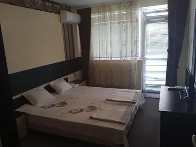 a bedroom with a bed and a window at Къща за гости дани in Primorsko