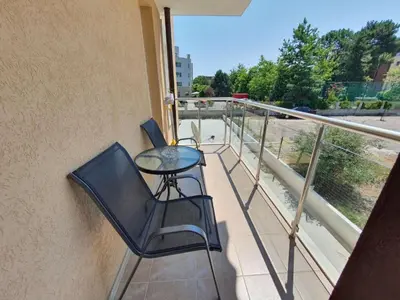 a balcony with a table and chairs on a balcony at Neptun-Blue in Primorsko