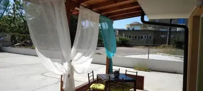 a room with a table and a window with white curtains at Neptun-Green in Primorsko