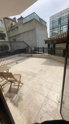 a bench sitting on a patio in front of a building at Studio paradise in Varna City