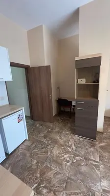 a room with a kitchen with a counter and a refrigerator at Studio paradise in Varna City